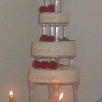 4 Tier Gold Buttercream on white cake with strawberry filling. the scroll work is royal icing painted gold. The top tier has Love, the second tier-...