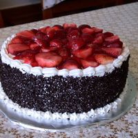 Stawberry Cake chocolate sponge cake filled with fresh cream and cranberry sauce ,covered by the same cream and topped with fresh strawberries and red...