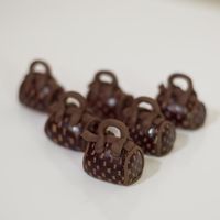 Mini Purses I made these hand painted mini purses out of fondant. They were placed on petit fours.