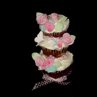 Stacked Cupcakes Chocolate cupcakes with baked cream cheese and coconut filling. Decorated with gumpaste flowers.