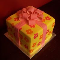 Birthday Gift Cake Fondant covered with Wilton Brush-On color stamped on; Wilton Ribbon Embosser bow and ribbon.