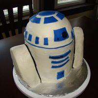 R2D2 Cake First 3D cake. Head made with 1/2 ball cake pan, than 2 8" rounds. Covered in buttercream and blue fondant accents.