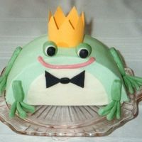 Prince Charming Cake covered in buttercream frosting with fondant legs, eyes, bowtie, and mouth. Paper crown.