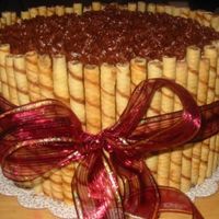 Pirouline Cake I made this cake for my office's Christmas party. 3 layer chocolate cake, filled with chocolate mousse and frosted in chocolate icing...