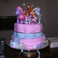 My Little Pony My twin girls' 2nd birthday cake - MLP theme. My fondant didn't turn out very stable nor symmetrical so plopped my daughters'...