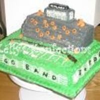 Football Stadium I did this cake for the high school band banquet this year. My brothers roped me into doing it and last years band banquet cake...both...