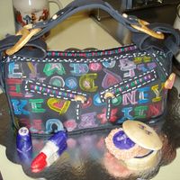 Dooney&bourke This is my first attempt at a purse cake. Decorated with fondant and gum paste. I used the actual purse as a guide.