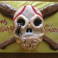Baseball Themed Skull And Crossbones Skull carved from football cake. Bats carved from 11x7 cake. Covered in fondant. Fondant centipede and lettering. Hand painted to look old...