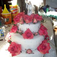 First Wedding Cake Fondant covered BC Yellow cake, with chocolate moose filling. Those are fake flowers.. But they were a big hit!