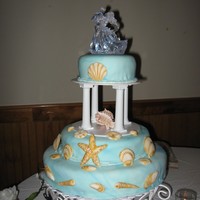 3Rd Wedding Cake blue marbled Fondant covered yellow cake. Sea shells are gumpaste.