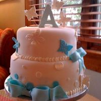 Ava's Communion Cake 2 tier WASC cake, fondant covered. Gumpaste and fondant accents. The child did not want a religious cake. Used rubber stamps to make...