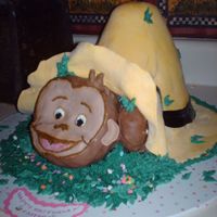 Curious George I made this for my neices bday. The hat is the wondermold cake and Georges face is ricekrispies shaped and all is covered in fondant.