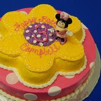 Minne Mouse Minnie cake for my daughters 3rd birthday. 14" bottom layer, Wilton flower pan. Buttercream with fondant dots. Minnie is plastic.