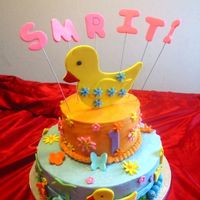 Duck Cake Done for a little girls 1st B'day who loves duck. The duck topper was made to match her toy duck. All buttercream with fondant accents...