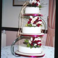 Roses And Lilles 3 Tier Wedding Cake I made this wedding cake for a mate this year. Two of the tiers were chocolate cake with a Bailey's Buttercream, the other one was a...