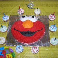 Elmo 1St Birthday Cake Used the Wilton Elmo pan and did additional cupcakes with crayon candles. Elmo is covered in star tip, and used my finger dipped in...