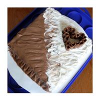 Mother's Day Cake Chocolate chip cake, iced and filled with 1/2 chocolate, 1/2 vanilla buttercream. Curls for heart were made from tootsie rolls.