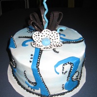Jazzy White and Chocolate cake with Cookies and Cream Filling, buttercream frosting. Gumpaste flower, chocolate ribbons