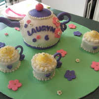 Tea Party Cake Cake covered in MMF. Tea cups are cupcakes.