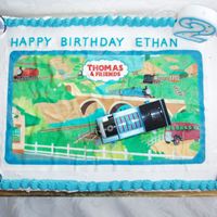 Thomas The Tank My sons Thomas the tank bithday cake (2 year old) I used edible image and decoated with train and party rings. This is an ice cream cake.
