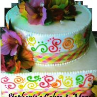 Birthday Swirls Birght Swirls with bright colored hibiscus flowers w/ crystals accented this cake for an 80th B-Day Party.