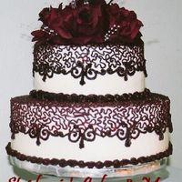 Cornelli Elegance The couple wanted a small simple cake with a lace pattern and the color maroon, the flowers are accented with pearl sprays.