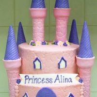Princess Alina Iced in BC. Turrets and tops made from a wrapping paper tube and ice cream cones. Covered in MMF. Royal icing flowers. MMF accents.