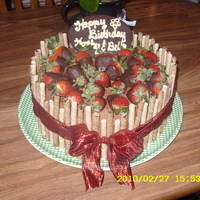 Strawberry Basket Gold cake, Chocolate Buttercream Frosting, Chocolate dipped strawberries, and Piroet Cookie trim. For friends Bday.