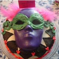 Mask Cake This cake was for my 12 year old sister's party today. She wanted to have a "masquerade." The mask is colored candy melts-...