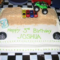 Pic479.jpg Vanilla cake with BC icing. The ramps for the monster truck are actually Little Debbie cakes covered in Nilla wafers.