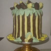 Chocolate 70Th Birthday Chocolate mudcake with chocolate fondant and lemon yellow coloured white chocolate fondant. Ribbon roses.