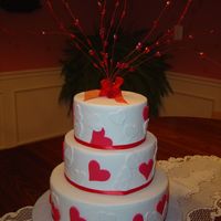 Valentine's Day, Hearts This cake was done for a local cake store window for Valentine's Day. The hearts are made of fondant and the cake is covered in...