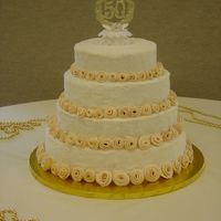 50Th Anniversary Cake I did this cake for a 50th wedding anniversary party. The flowers were all ivory colored fondant and sparking sugar covered the buttercream...