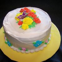 Carrot Cake Homemade carrot cake with white chocolate cream cheese icing and chocolate butterfly. Flowers are royal icing.