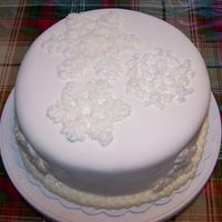 Snowflake Red Velvet Cake Snowflakes made from royal icing and sanding sugar. Red velvet cake covered in buttercream dream and Satin Ice fondant. Delicious!!!