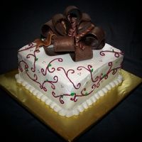 White Chocolate Birthday Cake French vanilla and strawberry layer cake with white chocolate frosting and fondant bow.