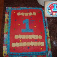 Johnathan's First Birthday Vanilla cake with buttercream frosting and Earth's Best Alphabet Block cookies. It's hard to see, but the blocks spell out HAPPY...