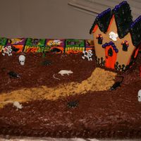 Devin's 8Th Birthday / Halloween Party 1/2 Darn Good Chocolate cake and 1/2 Butter Cake with b/c icing. Wilton Cookie House.