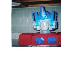 Optimus Prime Optimus is made with cake for his chest and shoulders. He has a styrofoam head with lots of fondant to create his unique look.