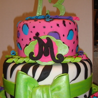 Birthday Cake Covered in fondant, gum paste bow, numbers, and letter. Birthday girl wanted zebra and leopard with lot's of bright colors.