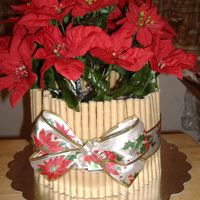 Poinsetta Cake. This was a quick cake I made for a friend. It was vanilla cake with barbarian cream filling and covered in BC. These are silk flowers and...