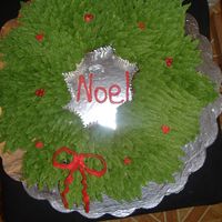 Wreath Cupcake Cake. These were chocolate and vanilla cupcakes put together to make a shape of a wreath and did lots of piping as you can see. Hope you enjoy it...