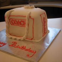 Coach Shopping Bag made this cake for my co-worker it is supposed to be a small shopping bag from coach. fondant with royal piping.