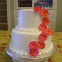 Tropical Wedding Cake for a small, tropical themed wedding. 6 and 9 inch rounds iced in Indydebi's amazing buttercream with gumaste plumeria.