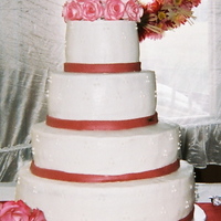 Tamyra's Cake My sister's wedding cake. 6, 9, 12, 15 inch rounds iced in Indydebi's buttercream with piped triple swiss dots, fondant ribbon,...