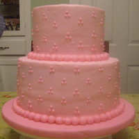 Bree's Cake 6 and 9 inch rounds iced in buttercream with piped swiss dots, fondant ball border and gumpaste letters spelling the baby's name.