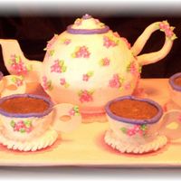 Teapot Cake Teapot Cake and cups iced with buttercream with fondant handle/spout.