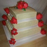 Red Tulips Buttercream with fondant ribbons. Gumpaste tulips.