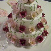 Whimsical Tulip Wedding Cake My husband (he's RockStarCakes on here) and I made this cake together. It is covered in white fondant. We made the flowers from...