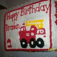Firetruck Cake This is for a little boy's birthday. It is yellow cake with strawberry filling and buttercream icing